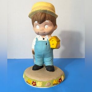 Cute Figurine with Blue Overalls and Yellow Hat